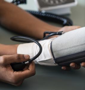Nurse taking someones blood pressure.